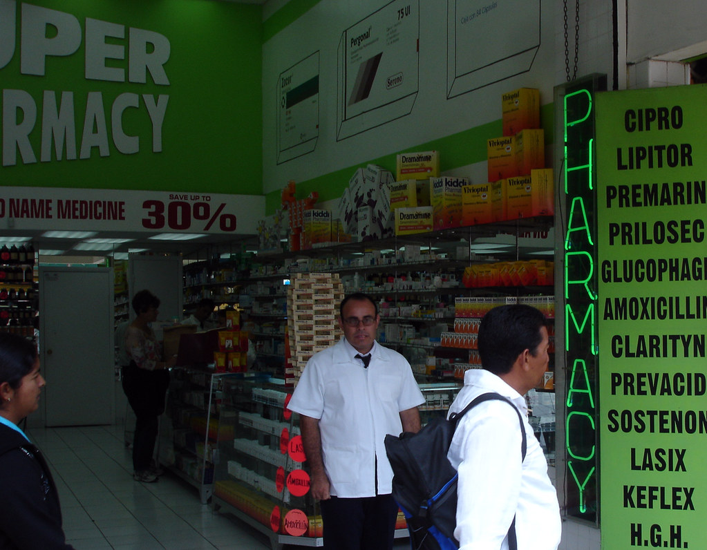 A pharmacist at Pharvest Pharmacy sitting down with a patient for a private medication counseling session