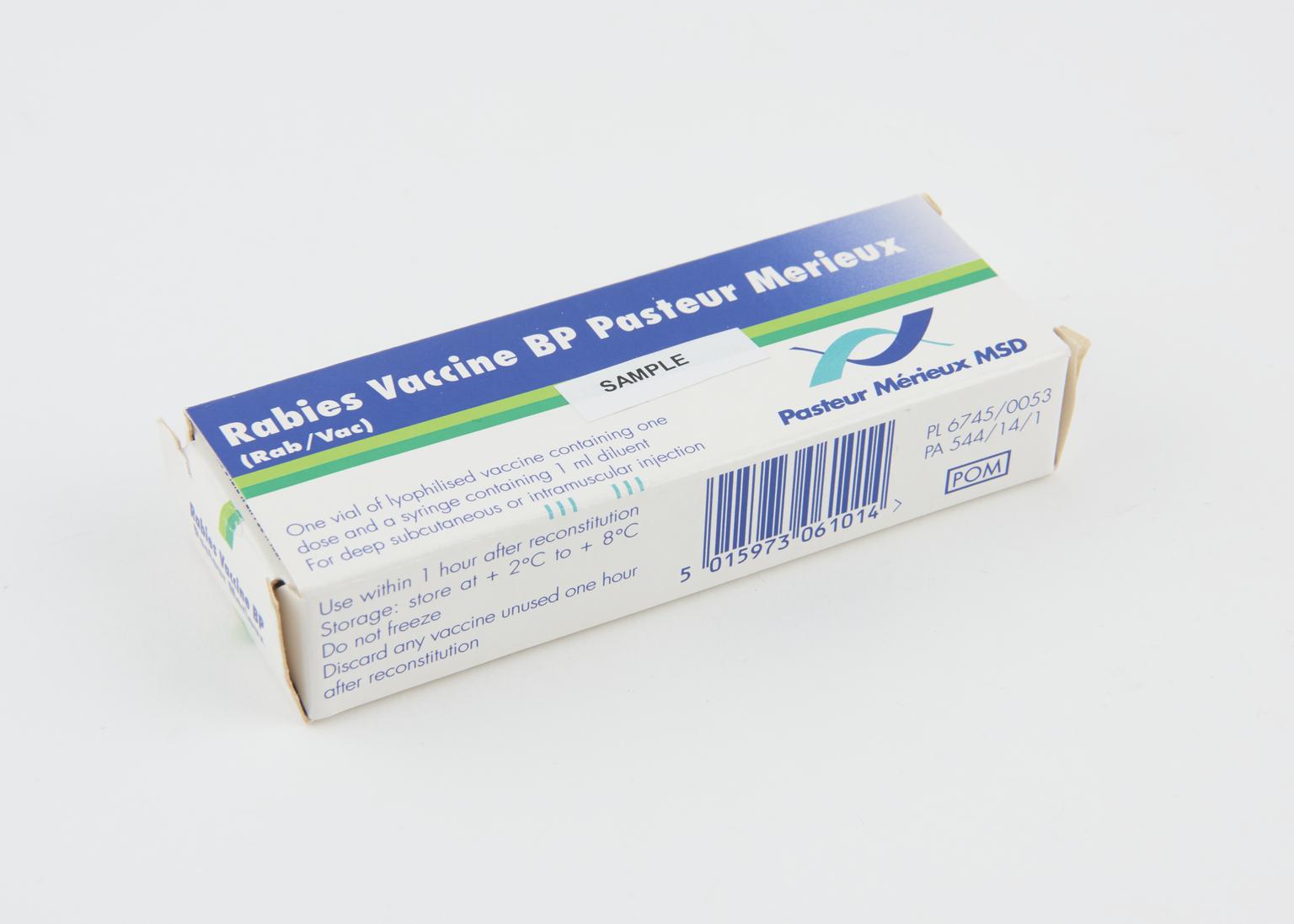 A pharmacist reviewing several medication bottles together to check for possible interactions